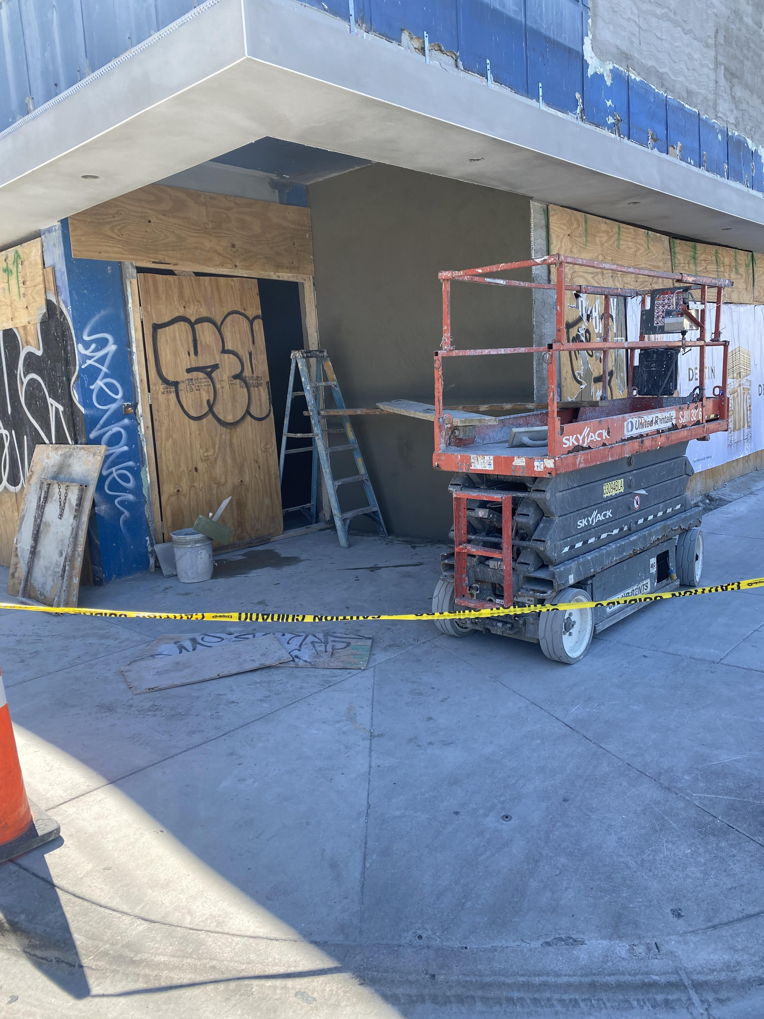 Active construction job site with scissor lift — visual context for installation planning