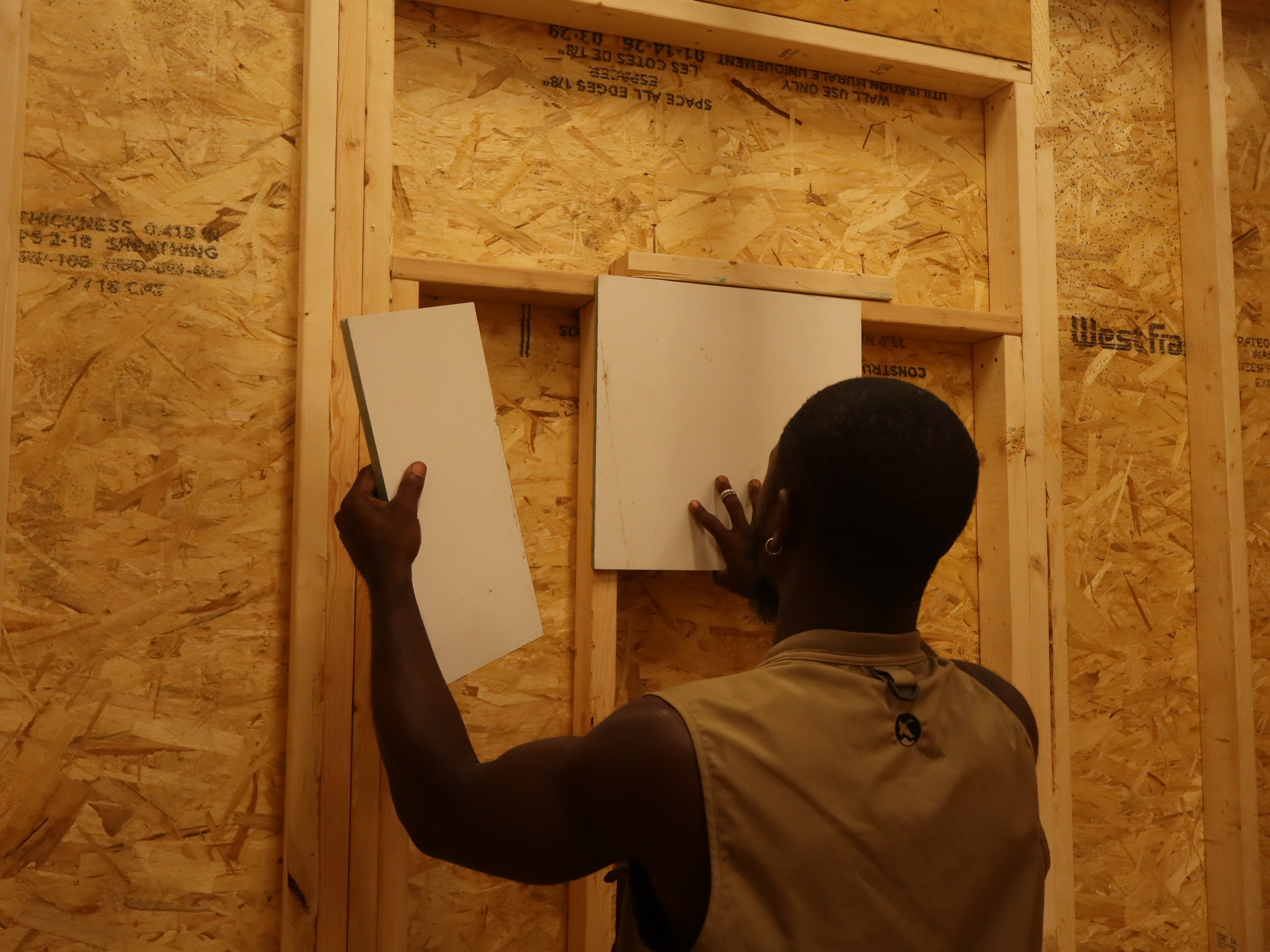 Rudy holding OmneBoard panels in the Pace Mayo workshop